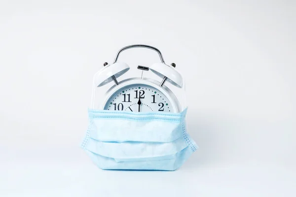 Picture of an alarm-clock covered with protective mask — Stock Photo, Image