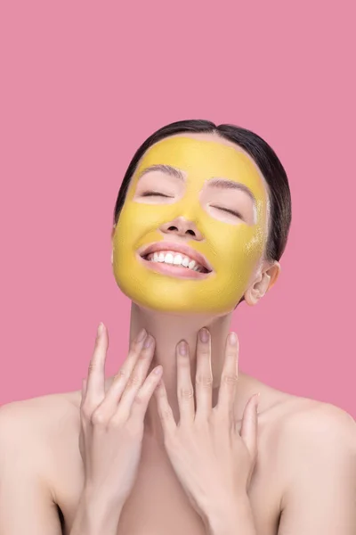 Dark-haired pretty asian girl enjoying having facial mask — Stock Photo, Image