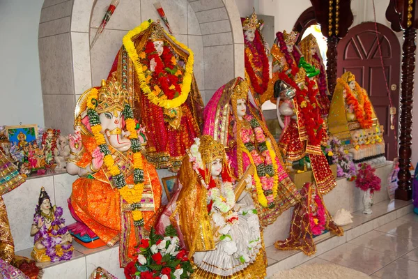 Colorful Hindu gods hung with flowers in a Hindu temple. World tourism, wedding, marriage.