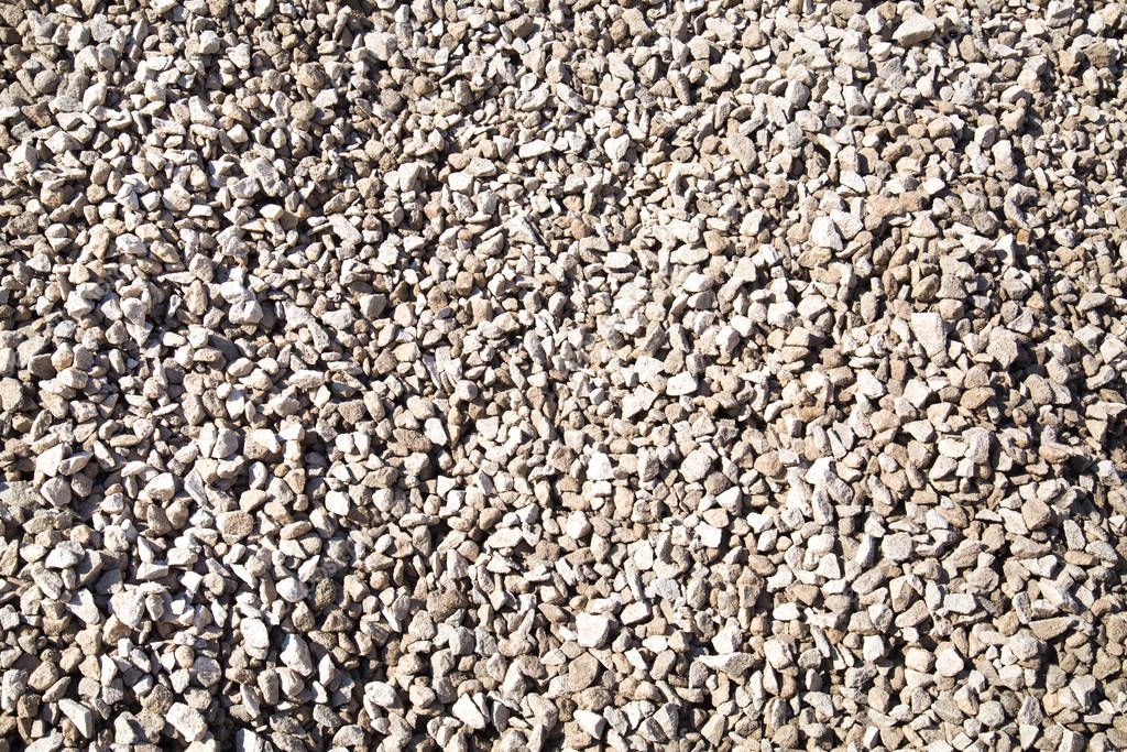 Background of white construction granite gravel on a bright Sunny day. Backgrounds, textures, interior.