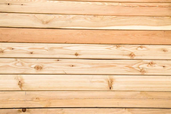 Background of light pine planed boards with knots and beautiful wood structure, texture design.