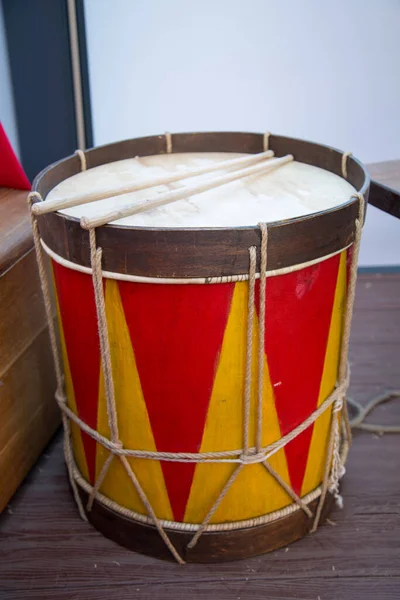 Folk instrument wooden drum painted in yellow red. Folk wooden art.  Leisure Hobbies.