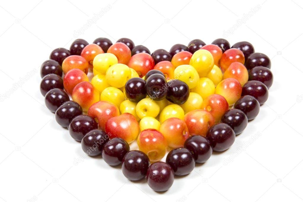 Cherry berries cherries in the form of a heart of red pink yellow isolated on a white background, a place for the text of the concept. Selective focus. Food ecology and agriculture. Background design.