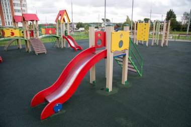 Wooden slide on the Playground of the city. Landscaping landscaping of cities. clipart