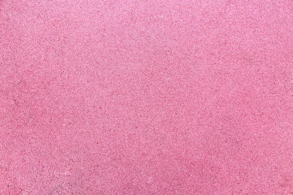 Çocuk ve spor sahalarında kullanılan kaplamaların arka planı pembe. Arkaplan dokusu tasarımı.
