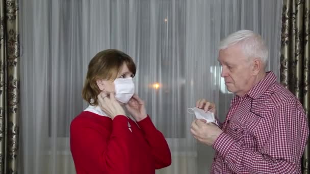 Middle Aged Woman Helps Elderly Man Put Medical Mask Protect — Stock Video