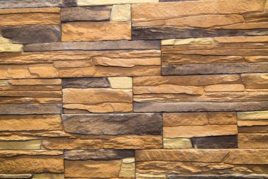 Arkaplan düzensiz dikdörtgen şekilli ve çeşitli boyutlarda kahverengi yapay taştan yapılmıştır. Arkaplan, doku ve tasarım.