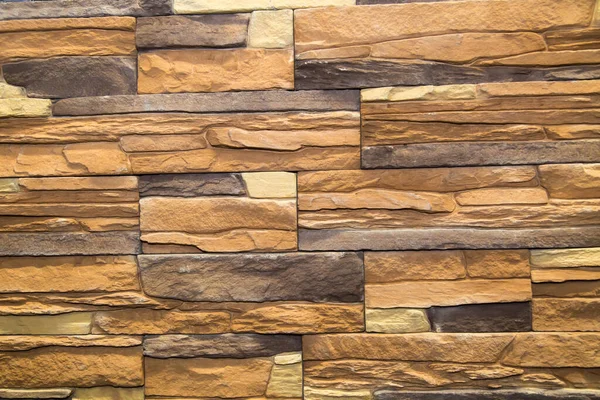 Arkaplan düzensiz dikdörtgen şekilli ve çeşitli boyutlarda kahverengi yapay taştan yapılmıştır. Arkaplan, doku ve tasarım.