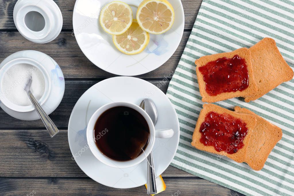 Breakfast with tea and rusks with jam