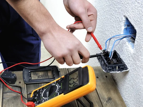 Joven electricista trabajando en una instalación eléctrica residencial —  Fotos de Stock