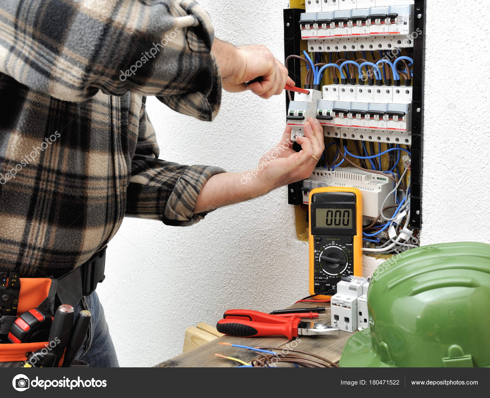 Electrician technician at work on a residential electric panel Stock Photo  by ©francescomoufotografo 180471522