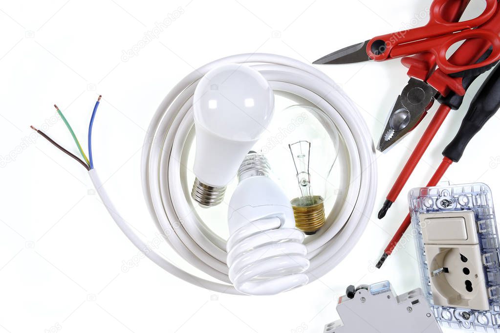Top view of working tools and components of the electrical system on white background.