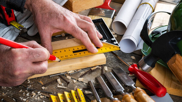 Craftsman at work on wooden boards. Carpentry.