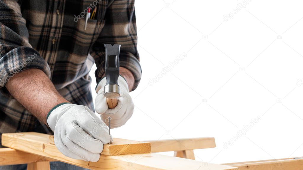 Carpenter at work on wooden boards. Carpentry.