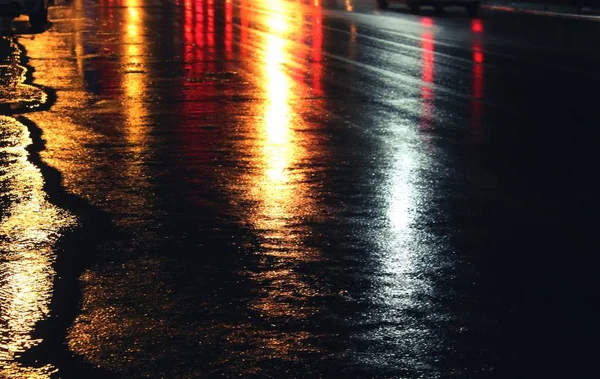City lights on wet road after rain, bokeh effect