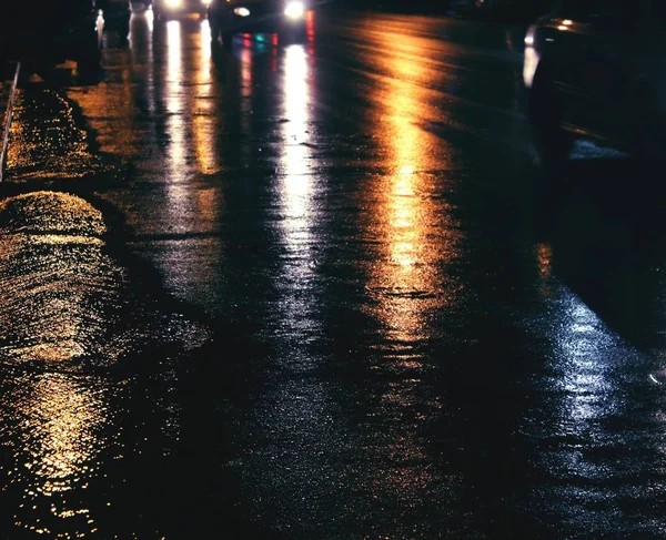 City lights on wet road after rain, bokeh effect