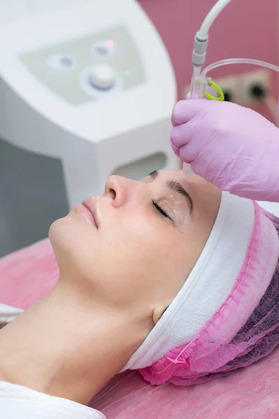 Woman getting face peeling procedure in a beauty SPA salon.
