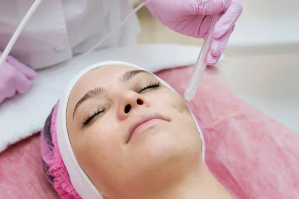 Mulher recebendo procedimento de descascamento de rosto em um salão de beleza SPA. Rej — Fotografia de Stock