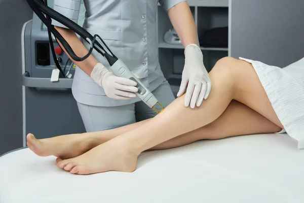 Hair removal cosmetology procedure from a therapist at cosmetic