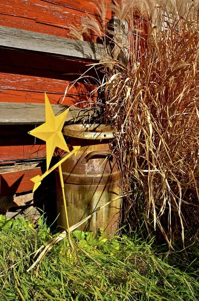 Old cream can in front of barn — Stock Photo, Image