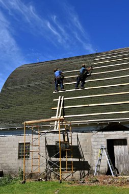 Repairing an old barn roof  clipart