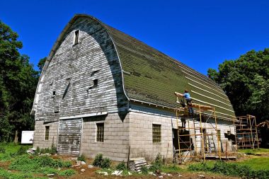 Repairing an old barn roof clipart