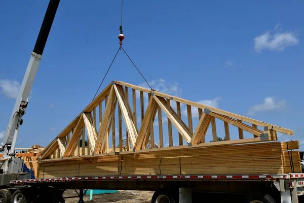 Μεταφορά trusses(rafters) στην κορυφή του ένα κτίριο υπό κατασκευή — Φωτογραφία Αρχείου