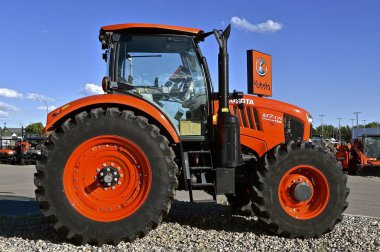 FARGO, NORTH DAKOTA, Aug 12, 2017: The Kubota M7-71 tractor on display is a of product of Kubota Corporation, a tractor and heavy equipment manufacturer based in Osaka, Japan, established in 1890. clipart