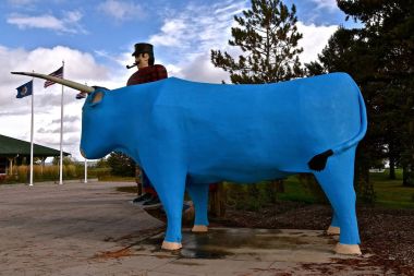 BEMIDJI, MINNESOTA, October 1, 2017: The legendary Paul Bunyan  and Babe the Blue Ox statues are tourist attractions run by the parks system of Bemidji, Minnesota. clipart