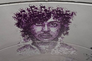CHANHASSEN, MINNESOTA, April 21, 2018: Memorials of drawings, illustrations, and notes are left on the concrete walls near Paisley Park in Chanhassan, the home of Prince Rogers Nelson as visitors leave comments clipart