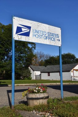 FORT RANSOM, NORTH DAKOTA, September 27, 2019: The distressed USPS sign advertises the post office location in the small town of Fort Ransom, North Dakota. clipart
