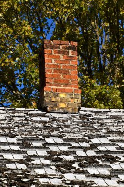Old chimney and house roof in disrepair clipart