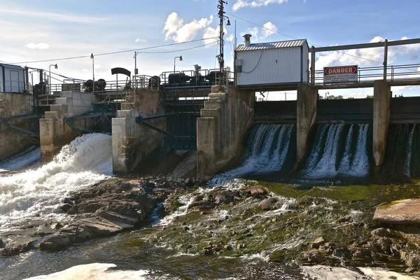 An old concrete poured dam with spillways only partially used.