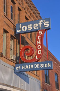 FARGO, NORTH DAKOTA, December 26: The outdoor sign representing Josef's School of Hair Design was located in Downtown Fargo for 57 years prior to moving in 2019.  clipart