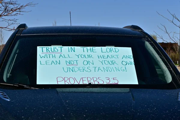 Proverbs Bible verse posted on car windshield urging trust in the Lord