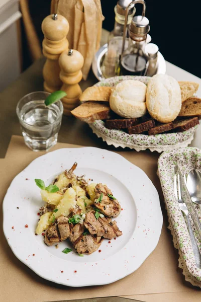 Grilled meat and boiled potatoes with herbs — Stock Photo, Image