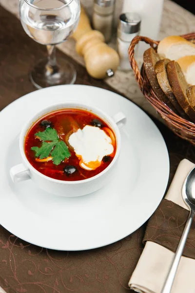 Tomato soup with olives and sour cream — Stock Photo, Image