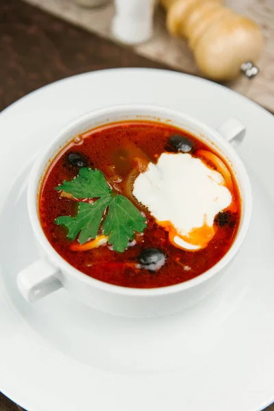 Tomato soup with olives and sour cream — Stock Photo, Image