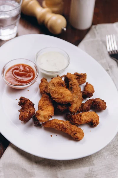 Fried chicken pieces on white plate