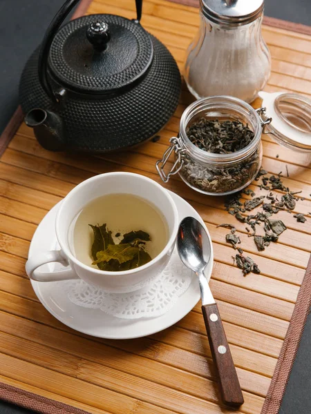 Cup, teapot and jar of tea Stock Picture