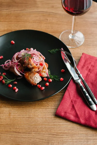 Roasted lobster meat with onions and pomegranate