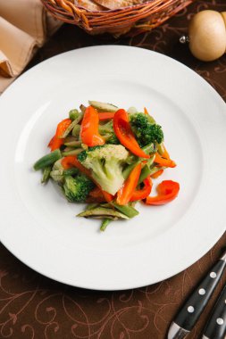 Brokoli, biber ve yeşil fasulye beyaz tabakta sebze salatası