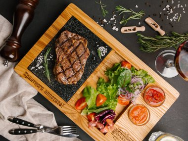 Kaburga-eti taş tahta üzerinde sebze salatası ile servis 