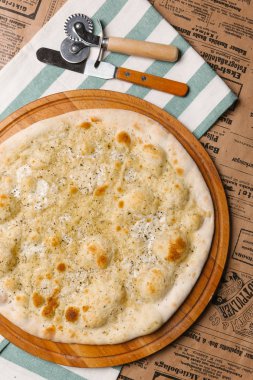 Çizgili peçeteye Calzone Parmesan ve mozzarella peyniri ile servis