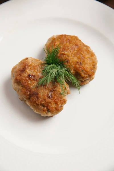 Two Chicken Cutlets Breadcrumbs Served White Plate Dill Branch — Stock Photo, Image