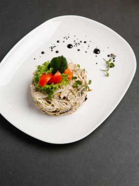 Sebze salata domates parçaları ve marul yaprakları eşliğinde