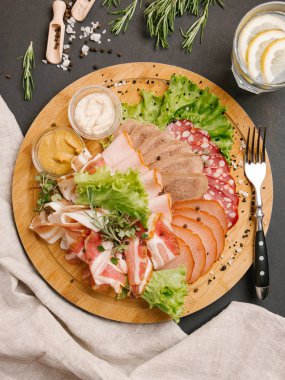 Soğuk et çeşitleri birlikte ahşap tepsi üzerinde kesmek.