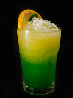 buz, Portakal dilim ve nane yaprağı ile süslenmiş parlak sarı yeşil alkol kokteyl