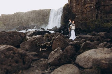 Örme Kazaklar şelale arka arkaya ve tutan ellerinde kalan genç çift giymiş