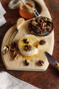 Tatlım kavanoz ve ceviz ahşap masaya servis ile iştah açıcı Brie closeup görünümü.